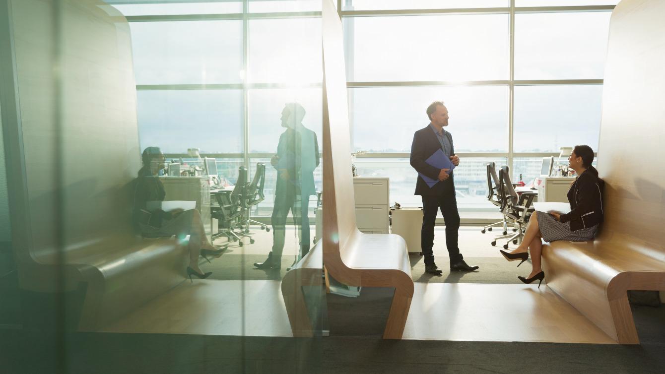 Two colleagues talking in an informal spot in the office