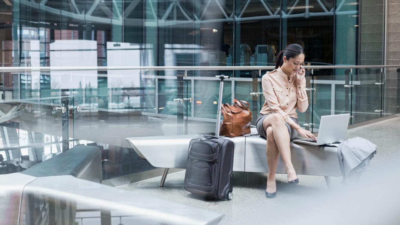 Woman using laptop in modern building