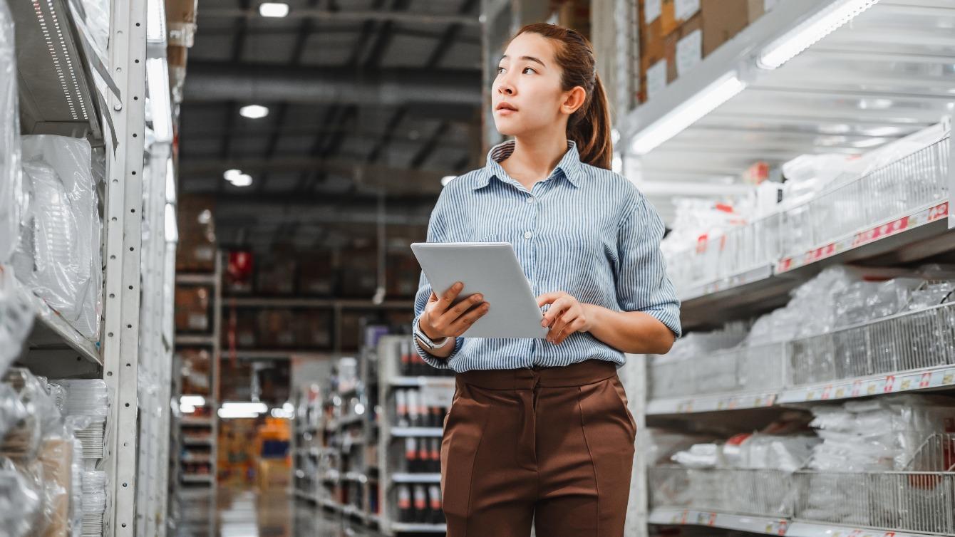 Woman finding stock in a supply warehouse